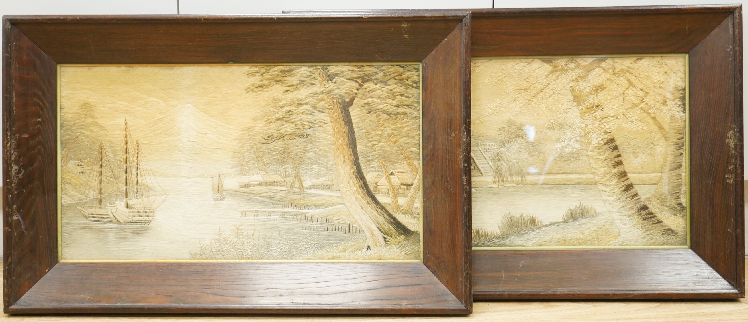 A pair of Japanese silk embroidered framed panels, 30 x 55cm